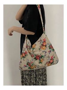 Side view of floral canvas tote bag with vibrant flowers and large storage capacity