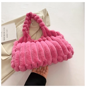 Close-up of pink faux fur tote bag showing vertical plush texture and soft handle