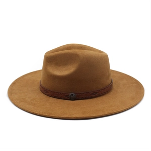 Close-up of brown suede fedora hat featuring a dark embossed band and vintage round ornament