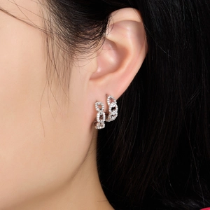 Close-up of S925 sterling silver chain earrings with pavé set sparkling white zircons