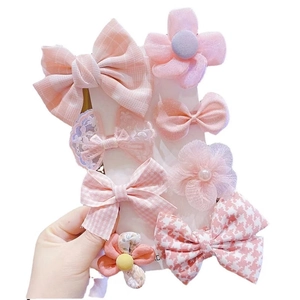 Pink fabric hair clips set for girls featuring lace bows and floral pattern details