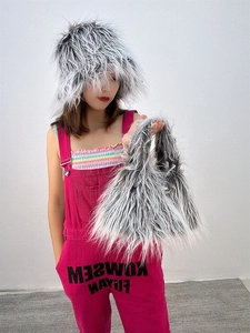 Detailed view of fluffy faux fur winter hat and matching plush handbag set in grey and white