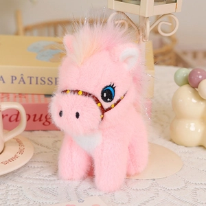 Close-up of cute pink plush pony with blue eyes on a lace cloth with warm home decor