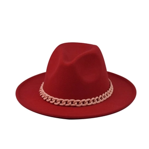 Detailed view of red wide brim fedora hat featuring a chunky pink chain decorative band