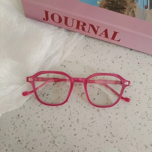 Rose pink children's square optical frame on a stylish marble background