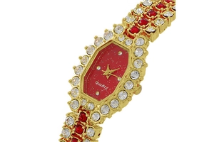 Detailed view of women quartz watch with red dial and sparkling gold crystal casing