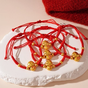 Set of five handmade red braided rope bracelets with gold charms for lunar new year