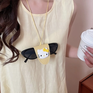 Detail of yellow leather glasses holder with Hello Kitty decor and black sunglasses