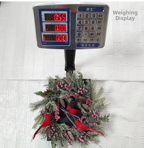 Weihnachtskranz mit roten Vögeln und Tannennadeln mit einem Gewicht von 0,55 kg auf einer Waage