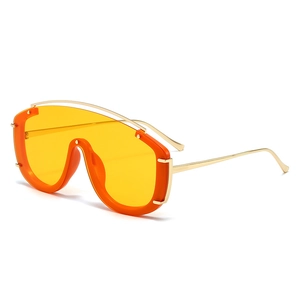 Futuristic orange shield sunglasses with oversized gradient lens and gold metal temples