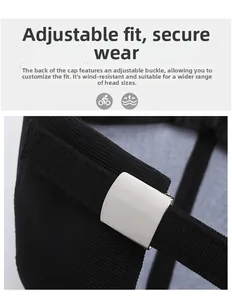 Detail view of the silver metal adjustable buckle on a black twill canvas baseball cap