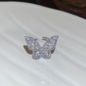 Macro shot of a silver butterfly ring with intricate zircon inlay on double-layered wings