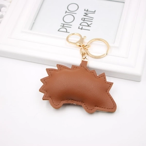 Detailed close-up of brown PU leather hedgehog keychain with gold metal ring clasp