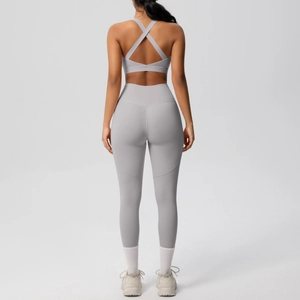 Rear view of light grey seamless yoga set with high-waisted leggings and strappy sports bra