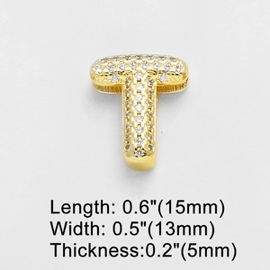 Macro shot of gold letter T charm pendant with cubic zirconia inlay and dimensions