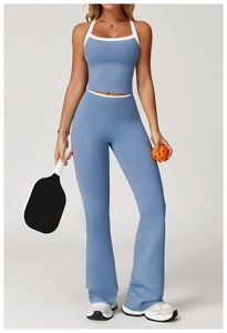 Women in grey-blue flared sports trousers and tank top holding a pickleball racket