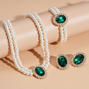 Detailed view of luxury double-layer faux pearl necklace set with green oval gemstones