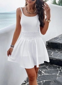 Close-up of white mini sundress showing textured elastic waist and soft fabric details