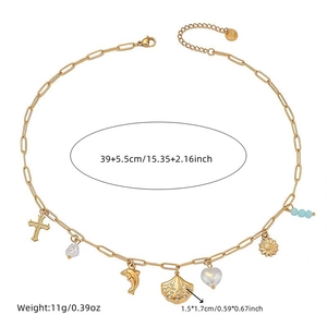Gold plated stainless steel necklace with shell, dolphin and cross charms on white background