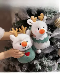 Close-up of white plush reindeer toys with embroidery and soft antlers for Christmas
