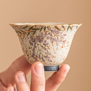 Hand-painted wisteria ceramic teacup with gold rim and speckled glaze finish
