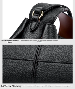 Detail of golden metal ring and reinforced stitching on black litchi leather handbag