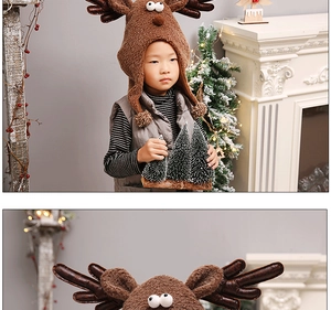 Plush brown reindeer hat with antlers and large eyes on a child in a Christmas setting