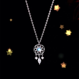 Macro shot of dreamcatcher necklace with moonlight blue stone and silver charms