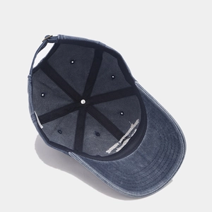 Detailed interior of a navy washed cotton baseball cap with reinforced seams and metal strap