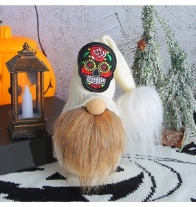 Detail of Halloween gnome featuring skull embroidery and long brown faux fur beard
