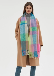 Close-up of thick checkered scarf with colorful tassels and soft plush texture