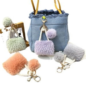 Plush mini bag keychain with faux pearl and fur ball charm in assorted pastel colors