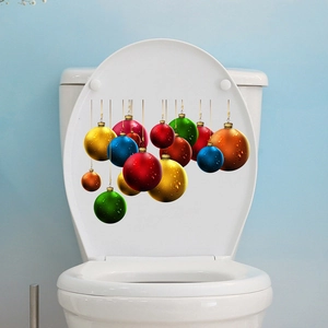 Detailed view of colorful Christmas ball stickers applied to a white toilet lid cover