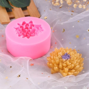 Detail of pink silicone peony mold and finished handmade flower candle with gold glitter