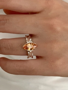 Close-up of marquise-cut orange zircon on an irregular texture silver ring