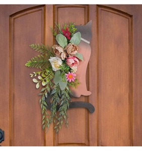 Detail view of cat-shaped wooden door hanging with white roses and pink peonies