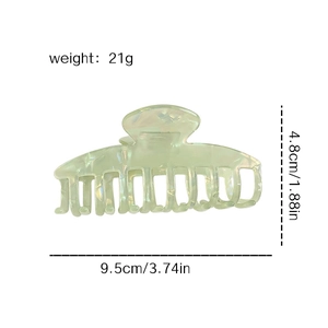 Pale green shell-patterned large shark hair claw clip with size and weight metrics