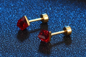 Macro shot of square red ruby stud earrings with gold finish and screw-back closure