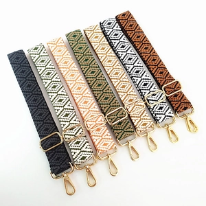 Detail of adjustable geometric jacquard bag straps with gold metal hooks in seven colors
