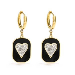 Macro detail of gold hoop earrings with black rectangular charm and zircon heart inlay