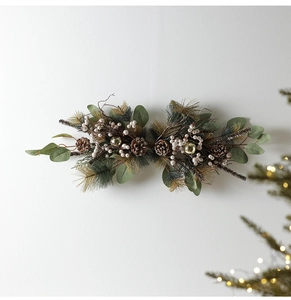 Detail of Christmas wall swag with pine needles, eucalyptus leaves, cones and white berries