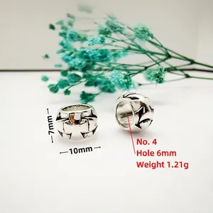 Macro detail of antique silver cross-engraved spacer bead with dimensions 10x7x6mm