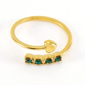 Golden open ring featuring a heart element and four green zircon stones on white background