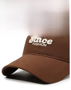 Macro shot of brown cotton baseball cap showing 3D towel embroidery and stitched brim