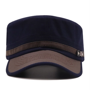 Detail of navy canvas cadet cap with brown leather brim and silver side buckle accent