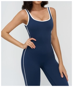 Close-up of navy yoga bodysuit with white contrast piping and elegant square neckline