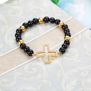 Elastic beaded bracelet with black beads, gold metal accents and sparkling cross charm