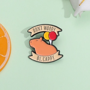Cute capybara enamel pin with Don't Worry Be Cappy slogan and colorful balloons