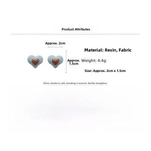 Detail view of denim blue fabric heart earrings with resin center and S925 silver needle