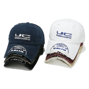 Distressed vintage baseball cap with ripped brim and custom embroidery in multiple colors